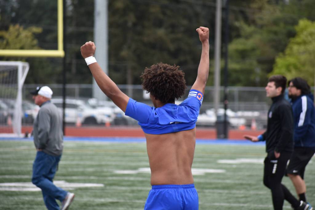 Nate Esayase raises his arms in celebration after the final whistle. Ben Ray / The Reporter