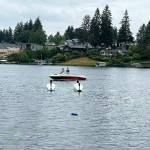 A boat near the upside down seaplane that crashed Saturday morning, Aug. 24 into Lake Meridian in Kent. COURTESY PHOTO, Puget Sound Fire