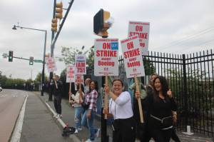 Workers stand outside of the Renton Boeing plant on the first day of the strike. Photo by Bailey Jo Josie/Sound Publishing.