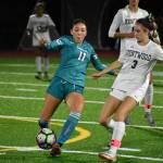 Raven sophomore Alexis Novoa takes on a Kentwood player. Ben Ray / The Reporter