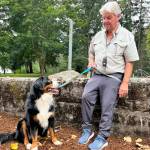 Left, Todd Weston and his dog, Sam, enjoy the ribbon cutting ceremony Oct. 1 at Game Farm Park.