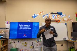 Master of ceremonies Grantley Martelly leads off the public safety meeting at Chinook Elementary. Photo courtesy of City of Auburn