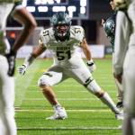 Mac Johns #51 of the Auburn Trojans warms up before a football game against the Sumner Spartans at Sunset Chev Stadium on Nov. 8. Photos by Henry Rodenburg