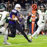 Braylon Pope #0 of the Sumner Spartans carries the ball during a football game against the Auburn Trojans at Sunset Chev Stadium on November 8, 2024 in Sumner, Washington. Photos by Henry Rodenburg