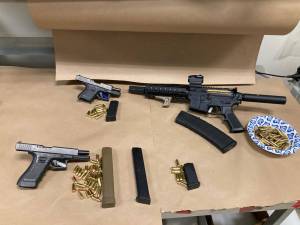 Three firearms and magazines retrieved from the suspects home and vehicle. (Photo courtesy of Auburn Police Department)