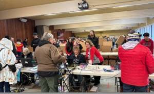 Auburn Food Bank Director Debbie Christian and Auburn Mayor Nancy Backus at the Dec. 23 annual Christmas distribution of food boxes for local people and families in need in the Fellowship Hall at Holy Family Catholic Church. Courtesy photo, City of Auburn.