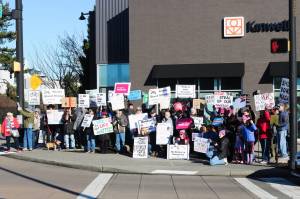 Fifty protesters held up a variety of signs at the Renton location for the Jan. 18, 2024 Womens March and Peoples March. Photo by Bailey Jo Josie/Sound Publishing.