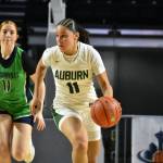 Auburns Kaleesa Howard dribbles the ball up the floor for the Trojans. Ben Ray / The Reporter