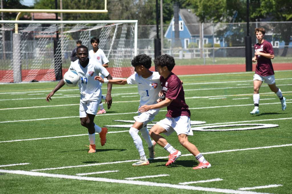 Jenish Thapa battles for the ball against Mercer Island. Ben Ray / The Reporter