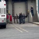 ICE and other federal agents escort people May 20 out of a Kent business. COURTESY PHOTO, Luis Cortes-Romero