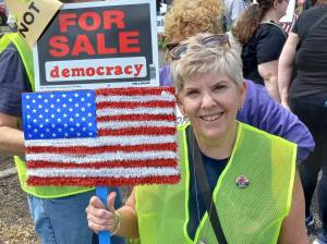 Vicki Bates, a former employee of the Auburn School District, at the No Kings protest. Photo by Robert Whale/Auburn Reporter