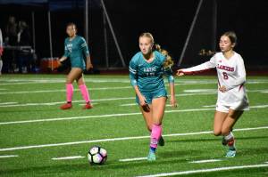 Raven junior Harper Curnutt keeps her eyes up as she searches for a pass against the Lancers. Ben Ray / The Reporter