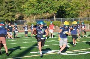 Rai Hampton runs through the Raven defense. Alexis Phung / For The Reporter