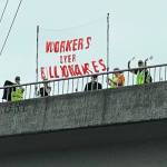 People display a banner Sept. 1 on an overpass above State Route 18 in Covington. COURTESY PHOTO, Indivisible Covington WA
