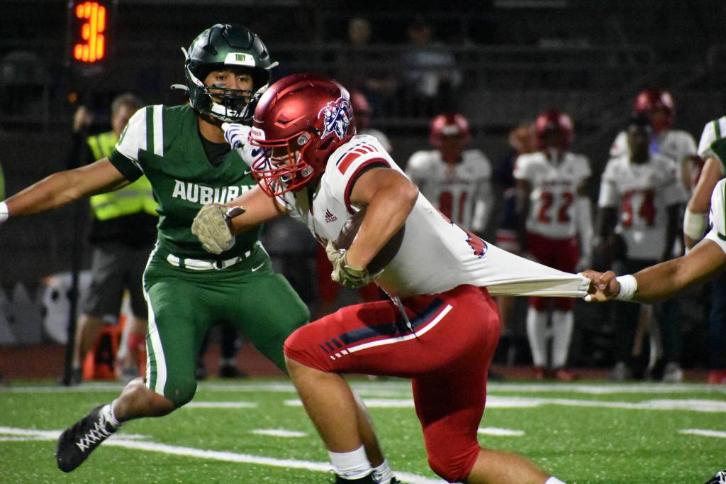 Kael Copeland of Kennedy tries to escape a tackle but has his jersey pulled by an Auburn defender. Ben Ray / The Reporter