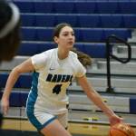 Cora Lowe drives to the basket during the lay-up line warm-up at Auburn Riverside. Ben Ray / The Reporter