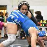 Yula Vi for Kentwood looks to dump her opponent from Auburn Mountainview. Ben Ray / The Reporter