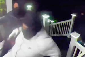 File photo
Security footage of the incident showed three masked men carrying guns and announcing themselves as Seattle police prior to attempting to kick down the door.