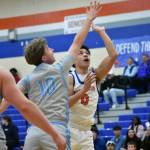 Kolven Posey lofts up a shot near the basket for Auburn Mountainview. Ben Ray / The Reporter