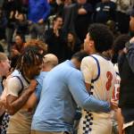 Auburn Mountainview head coach Kendall White (blue shirt) puts his arm around Markell Lowery (left) and Jarrick Matthews (right) after the win. Ben Ray / The Reporter