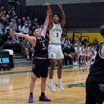 Auburn senior Daniel Johnson shoots a three-pointer. Nathan Hyun/For The Reporter