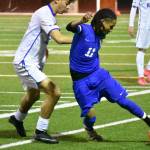 Ben Yitbarek shields the ball from Kent-Meridian defender. Ben Ray / The Reporter