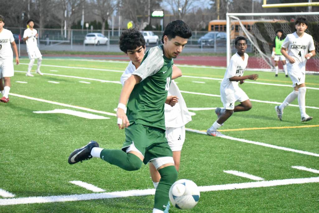 Ervin Camacho fends off a Kentwood defender. Ben Ray / The Reporter