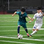 Joseph Rodriguez fends off a Tahoma player while dribbling the ball up the field. Ben Ray / The Reporter