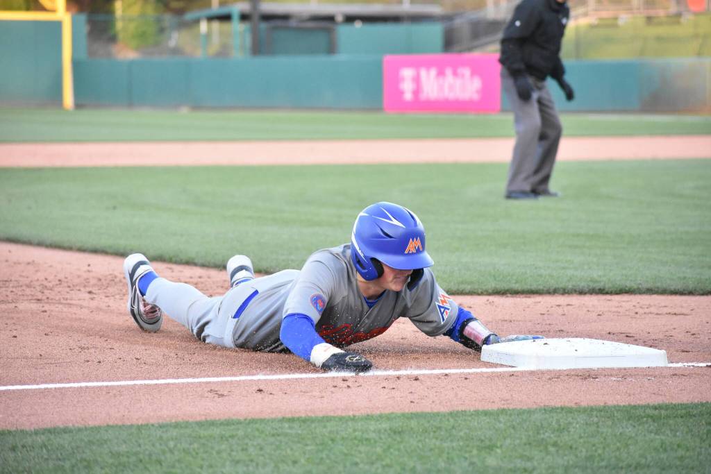 Maddox Shoul dives into third base. Ben Ray / The Reporter