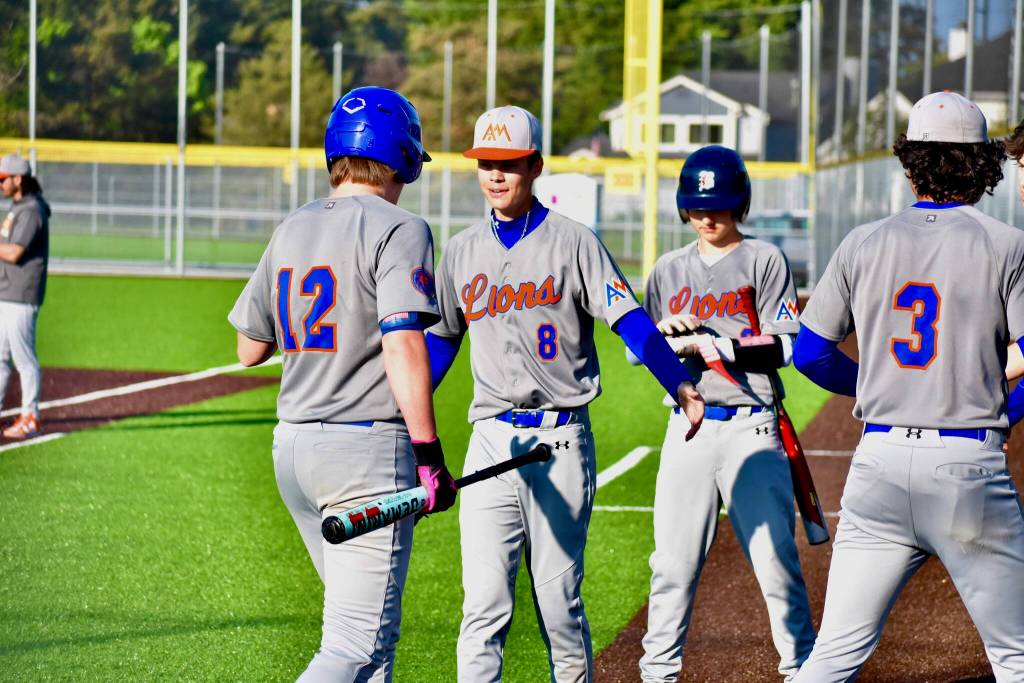 The Lions celebrate runs coming across to score. Ben Ray / The Reporter