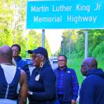 COURTESY PHOTO, Kent Black Action Commission
Gwen Allen-Carston leads a celebration May 26 of the newly installed Martin Luther King Jr. Memorial Highway sign along Benson Road in Renton.