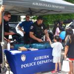 Auburn Police Department handing out stickers at KidsDay. Photo by Madeleine Goldberger