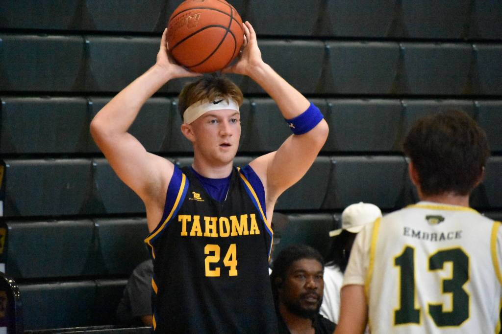 Tahomas Jake Moen holds the ball over his head for Tahoma. Ben Ray / The Reporter