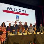 SnoValley Chamber of Commerce CEO Kelly Coughlin Games stands with candidates at a forum hosted by the chamber July 14, 2026. From left: Coughlin Games; Michelle Bennett; Zach Hall; Topher Leritz; Aimee Warmerdam; Maggie Adams; Adam James; Mike Steele. (Grace Gorenflo/Valley Record)